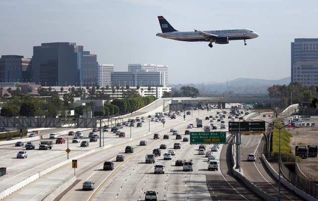 SANTA ANA, CA - NOVEMBER, 23, 2011: A U.S. Airways airplane flies over the 405 freeway as it approaches it's landing at John Wayne Airport in Orange County as travelers make their way to their destinations in time to celebrate Thanksgiving. ( Allen J. Schaben  / Los Angeles Times)